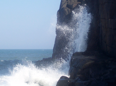 waves crashing against cliffs at Morgan Bay