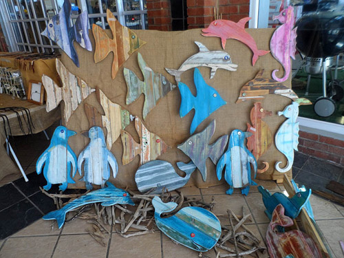 Reclaimed wood sea animal wall hangings at Terry and Tony's beachy craft stall at side entrance of Spargs in Beacon Bay in August 2018